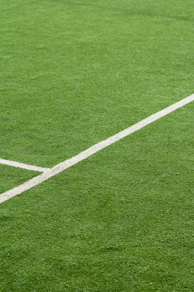 close up of green soccer field turf with white lines