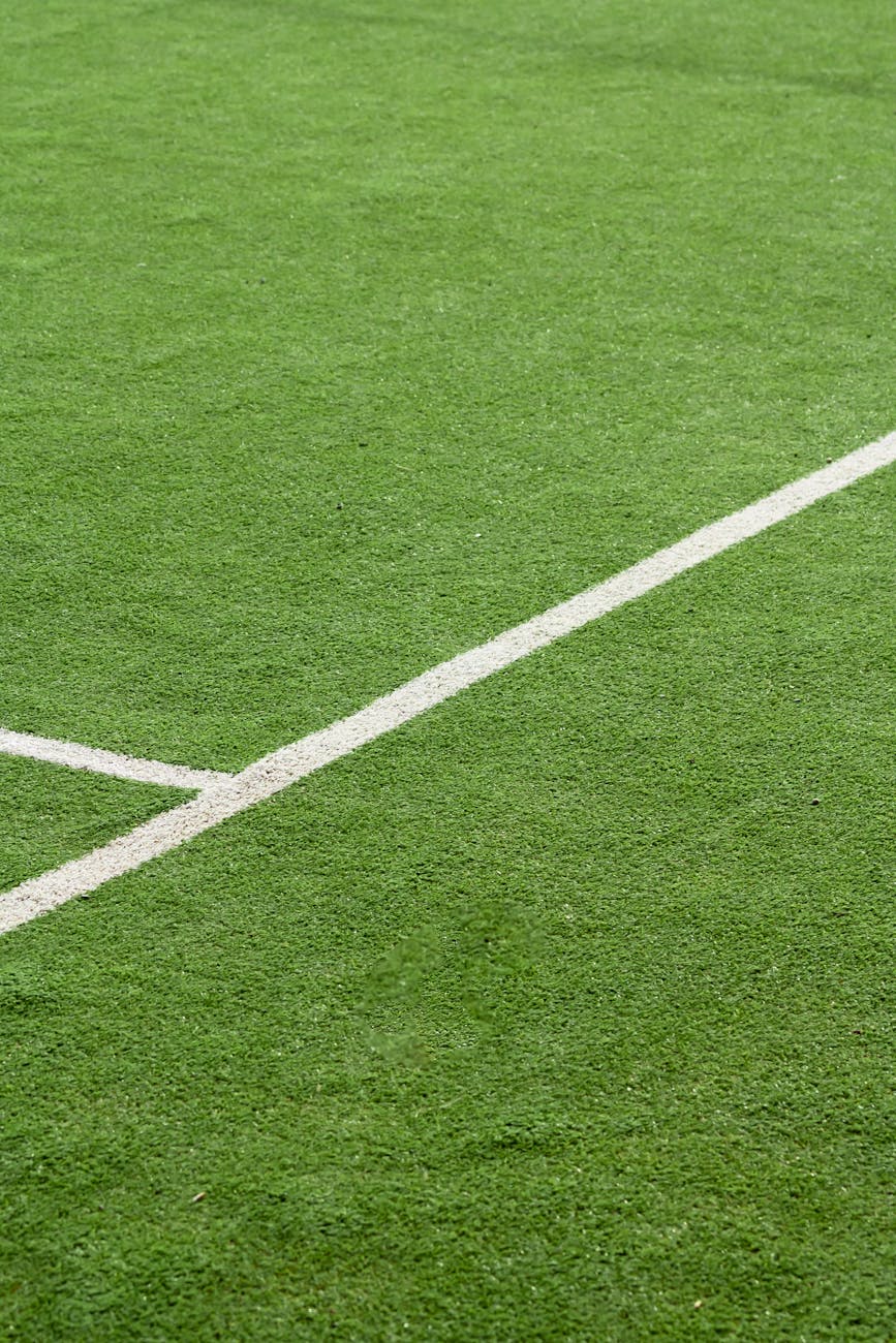close up of green soccer field turf with white lines