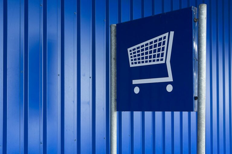 shopping cart on a blue signage